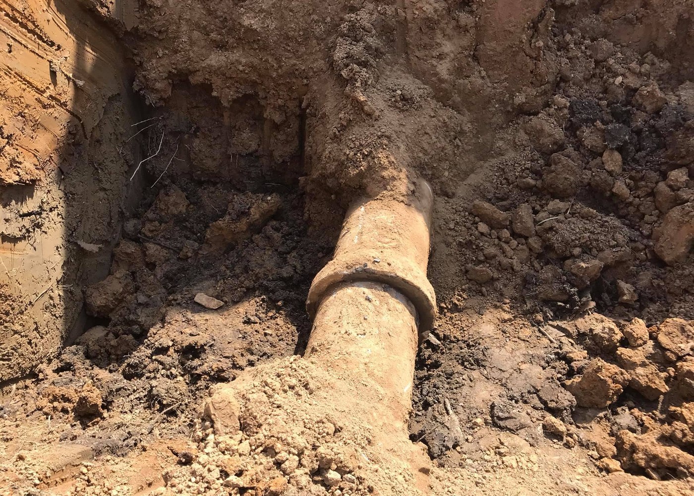 Close view of an underground line exposed in soil