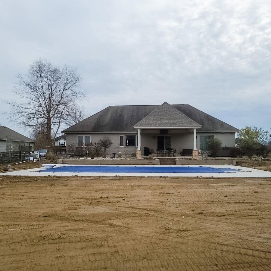 Residential pool area surrounded by freshly graded soil